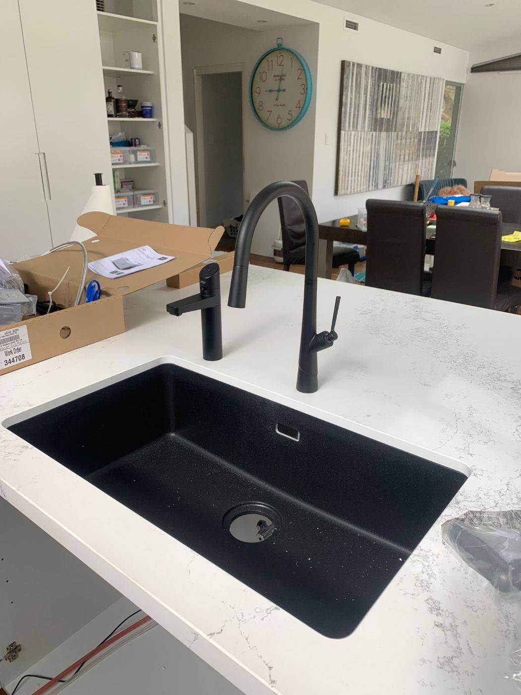 Under a kitchen sink with the pipework visible