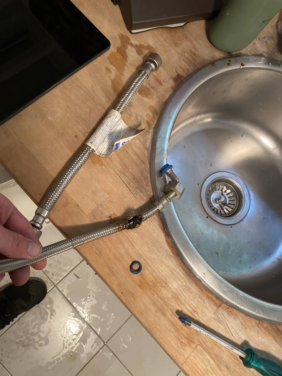 Water supply connections under a kitchen sink