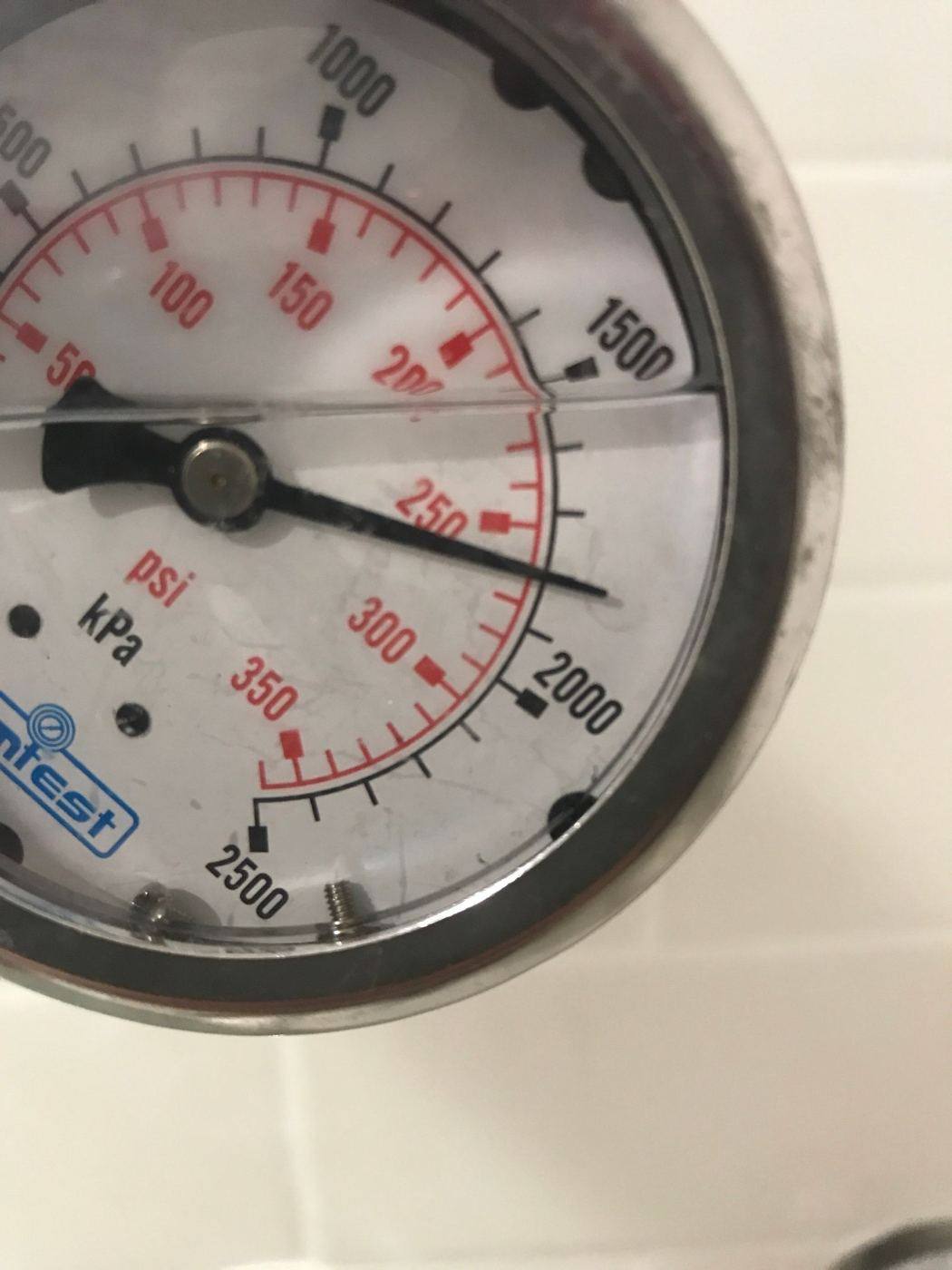 A pressure gauge fitted to a water line during a leak test