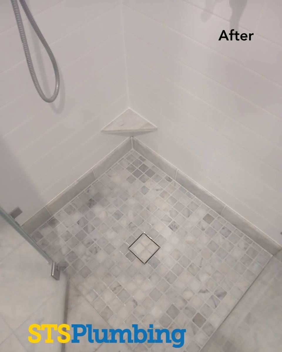 A finished tiled shower with a new floor waste