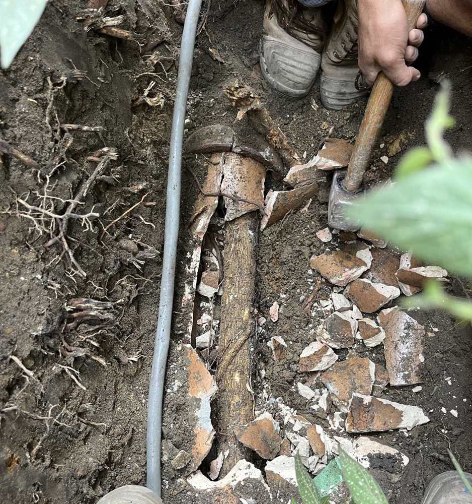 A split water pipe uncovered beneath a floor