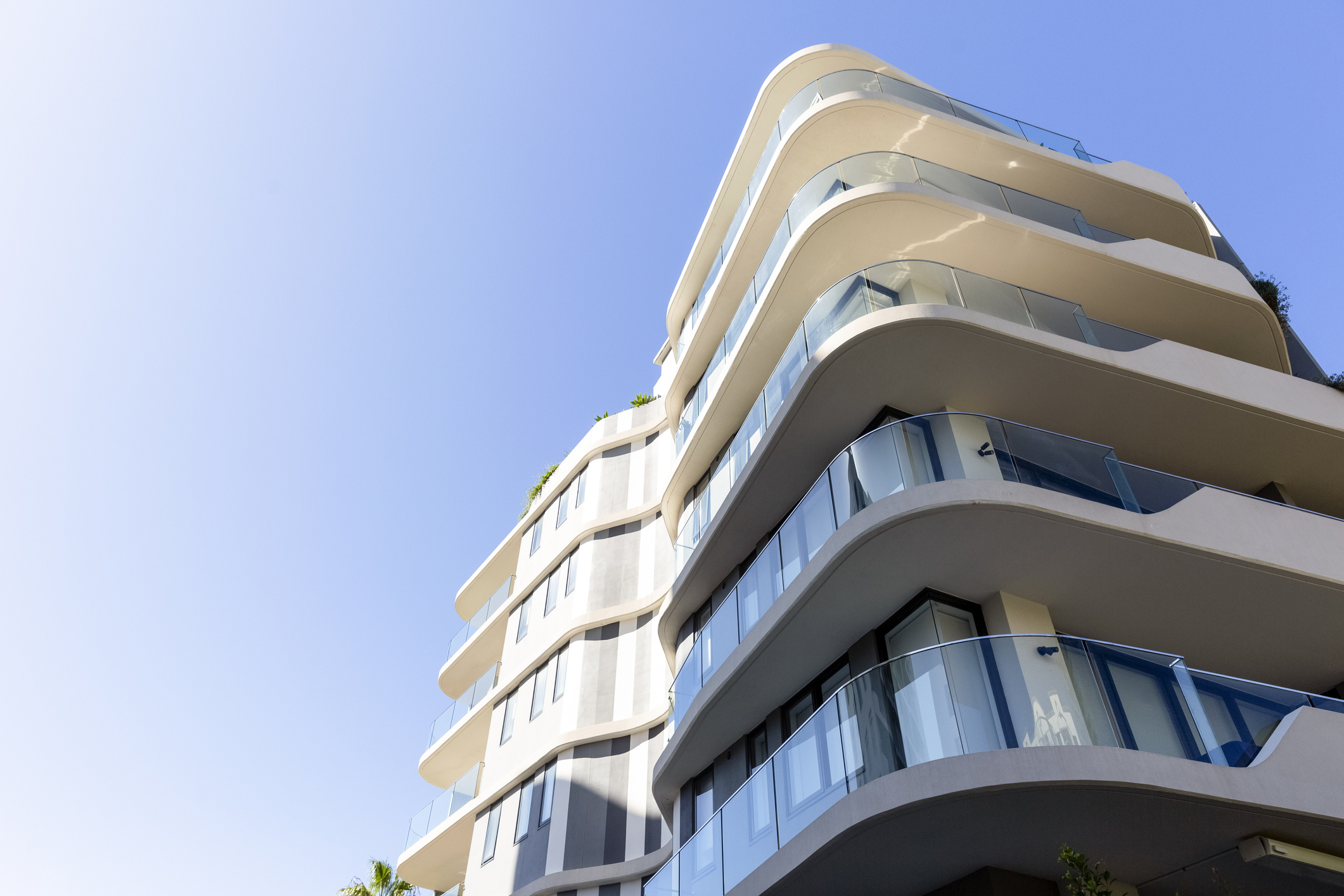 Modern apartment building, low angle view, blue sky background with copy space